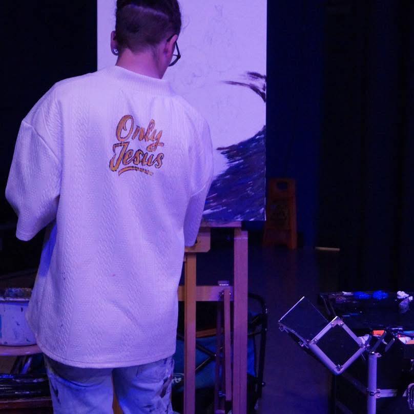 Dave prophetically painting at a worship event using acrylic 